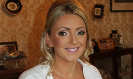 Bride on here wedding morning after makeup application beautiful tan and eyes french manicure in white robe beautiful white smile all set to put on her wedding dress. Ballina co mayo